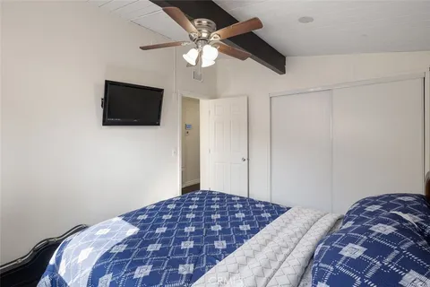 a bedroom with a bed and a flat screen tv