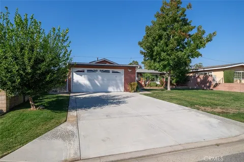 a front view of a house with a yard and a garage