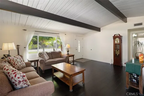 a living room with furniture a window and a table