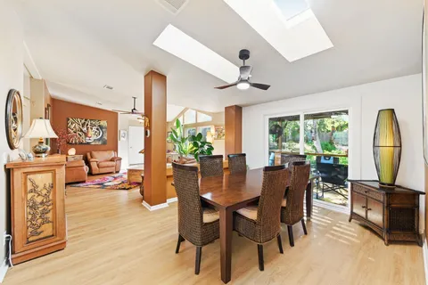 a living room with furniture a fireplace and a large window
