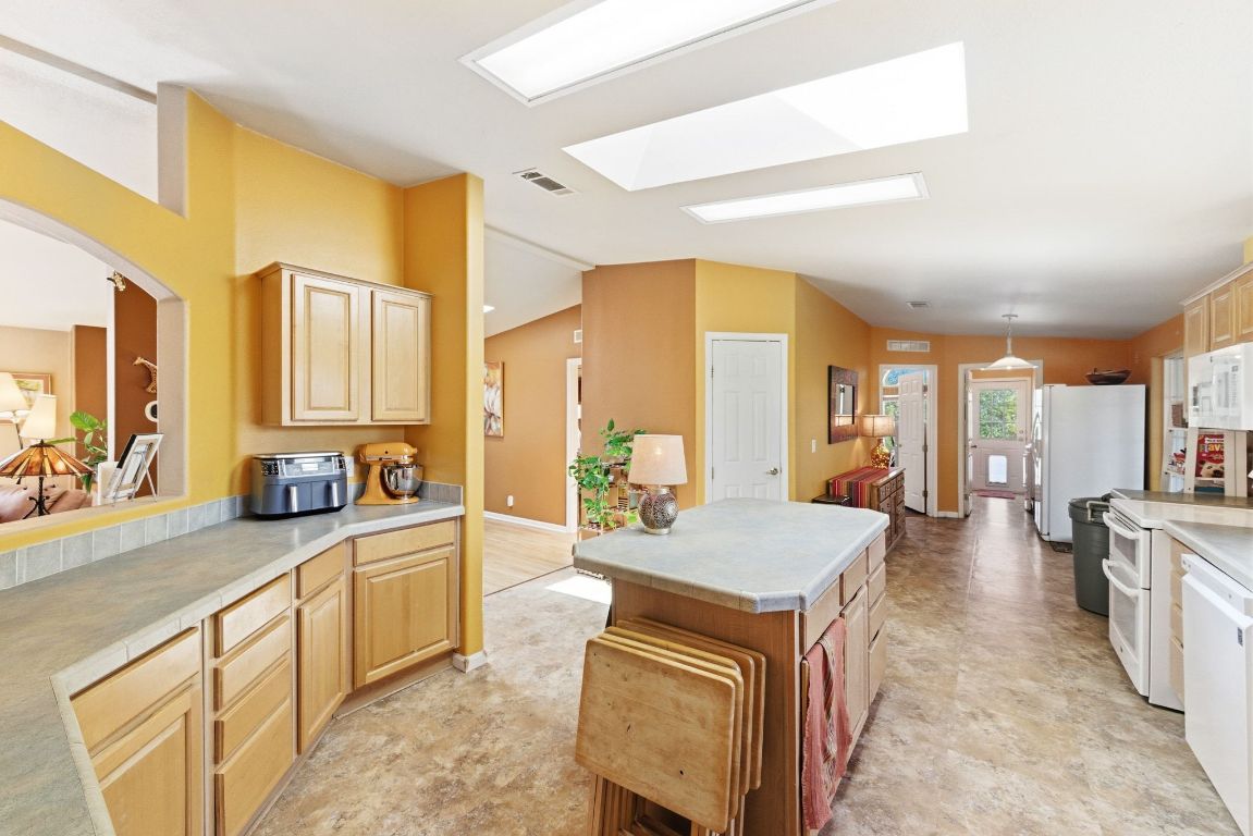 120 Cedar Bend Road Wimberley, TX 78676 - Photo 17 of 40 a large living room with stainless steel appliances granite countertop furniture a fireplace and a large window