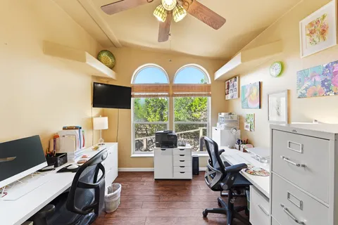 a living room with furniture and large windows