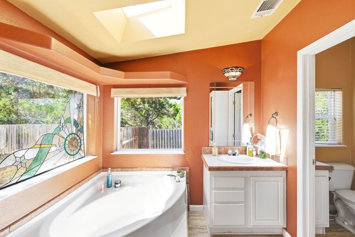 120 Cedar Bend Road Wimberley, TX 78676 - Photo 21 of 40 a bathroom with a large tub sink and mirror