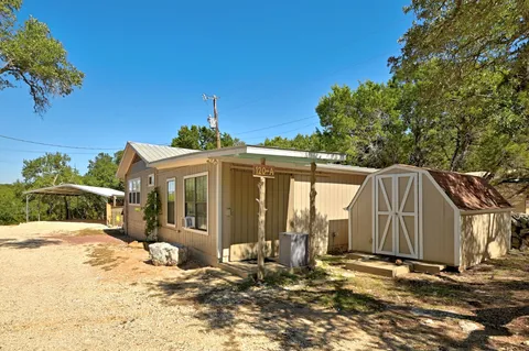 a view of a house with backyard porch and sitting area