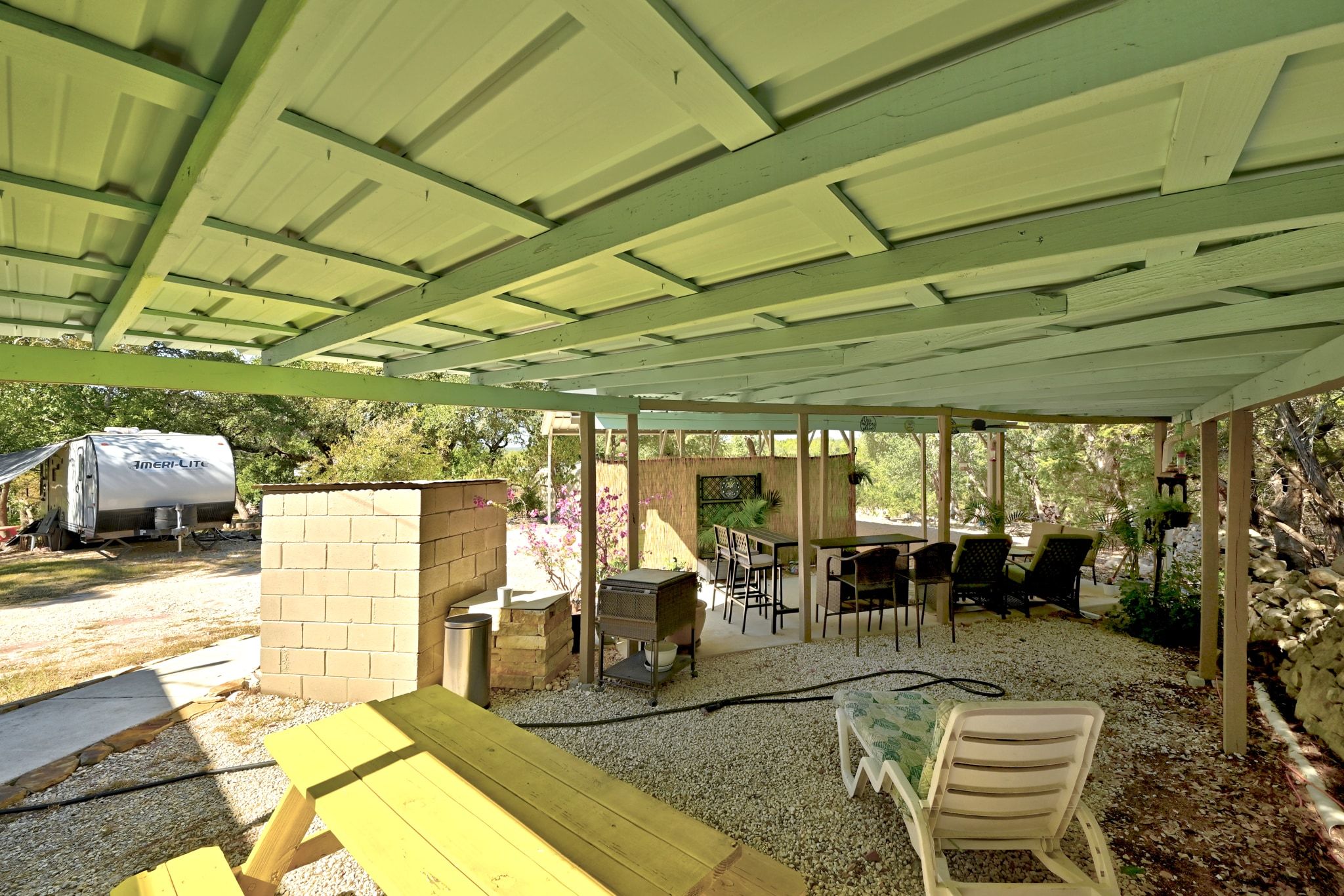 120 Cedar Bend Road Wimberley, TX 78676 - Photo 31 of 40 a view of a patio with table and chairs potted plants with wooden floor