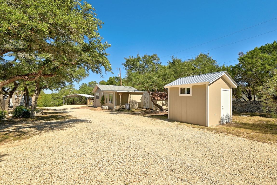 120 Cedar Bend Road Wimberley, TX 78676 - Photo 34 of 40 a view of a house with a yard and large tree
