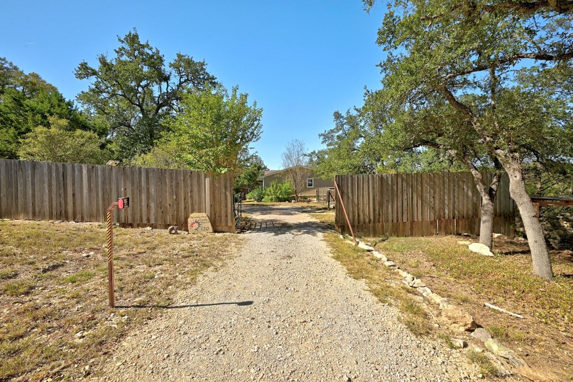 120 Cedar Bend Road Wimberley, TX 78676 - Photo 6 of 40 a backyard of a house with table and chairs