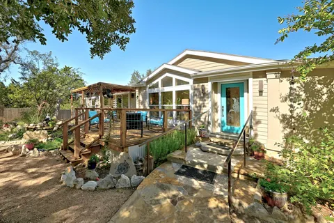 an outdoor sitting area with furniture and wooden floor