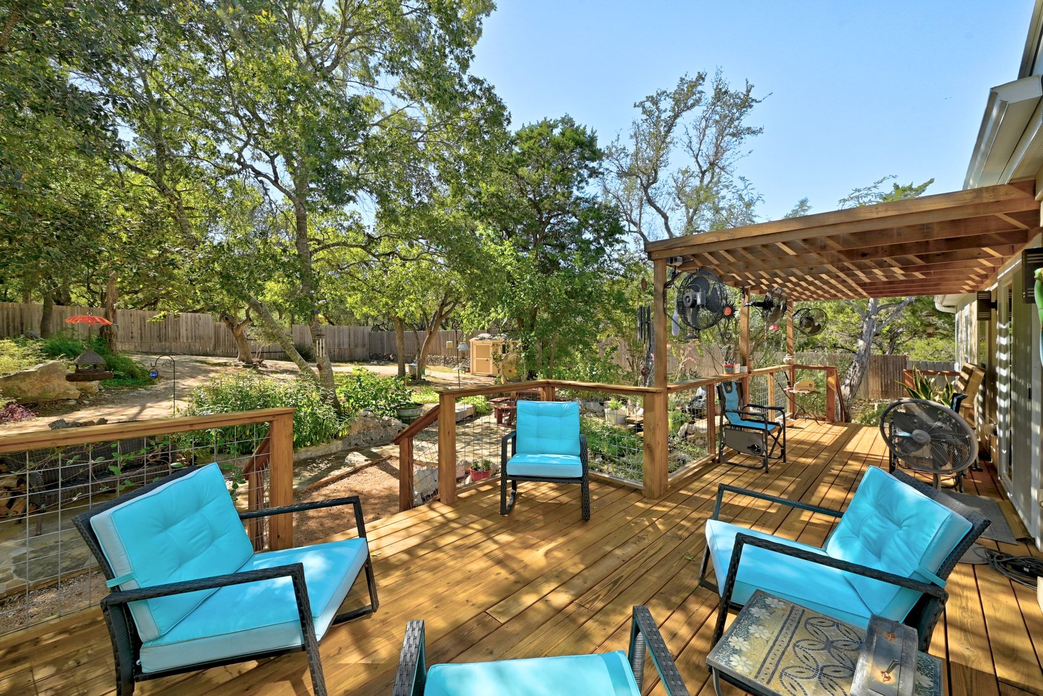 120 Cedar Bend Road Wimberley, TX 78676 - Photo 9 of 40 an outdoor sitting area with furniture and wooden floor