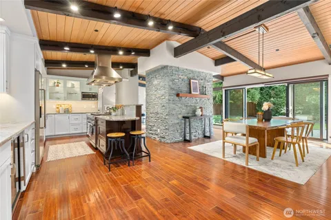 a living room with furniture a fireplace and wooden floor