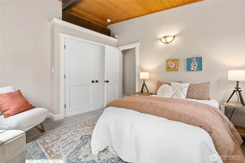 a spacious bedroom with a bed and a couch