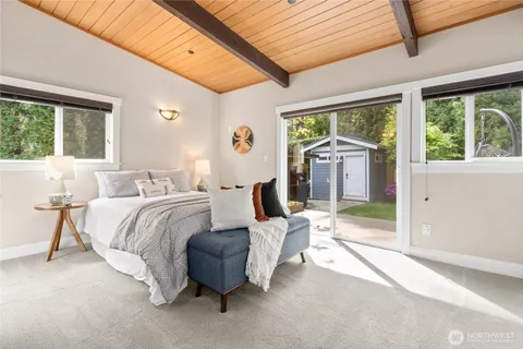 a bedroom with furniture and large windows