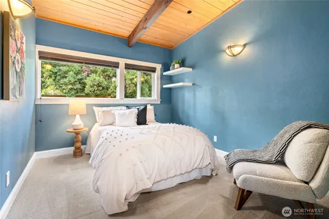 a bedroom with a bed couch and window