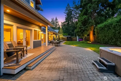 a view of a house with backyard and sitting area