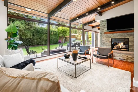 a living room with fireplace furniture and a flat screen tv