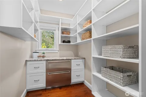 a kitchen with a stove window and cabinets