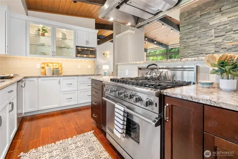 a kitchen with granite countertop stainless steel appliances and wooden cabinets
