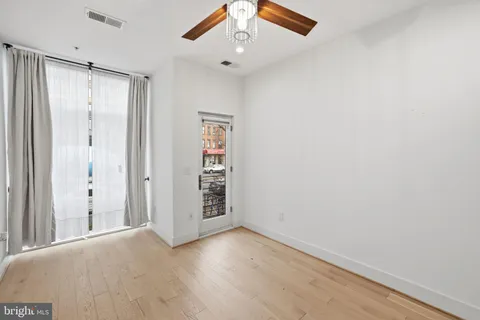 a bedroom with a large bed and potted plant