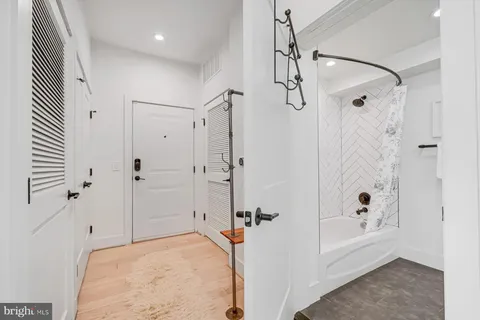 a bathroom with a tub shower vanity and a sink