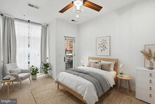 a living room with furniture and kitchen view