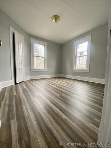 15-17 Ridgewood Street, Unit 2 Waterbury, CT 06710 - Photo 2 of 8 a view of an empty room with wooden floor and a window