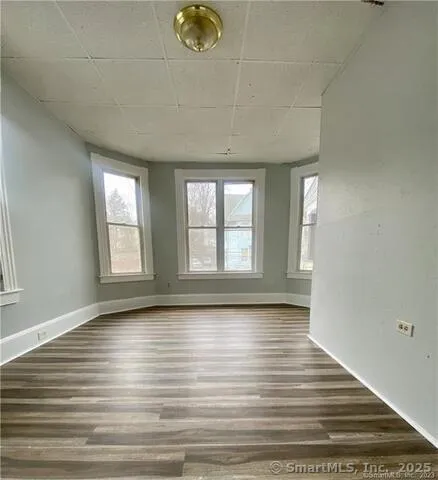 a view of room with window and wooden floor