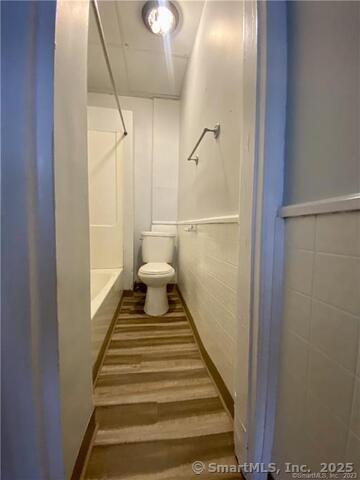 15-17 Ridgewood Street, Unit 2 Waterbury, CT 06710 - Photo 7 of 8 a view of a hallway with a white walls and stairs