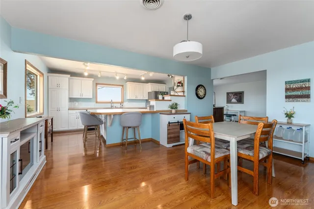 a large kitchen with kitchen island a stove a sink a refrigerator and a refrigerator