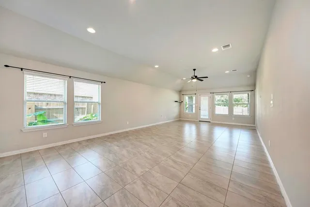 a view of empty room with ceiling fan