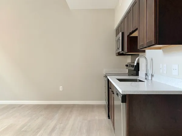 a kitchen with a sink and a microwave