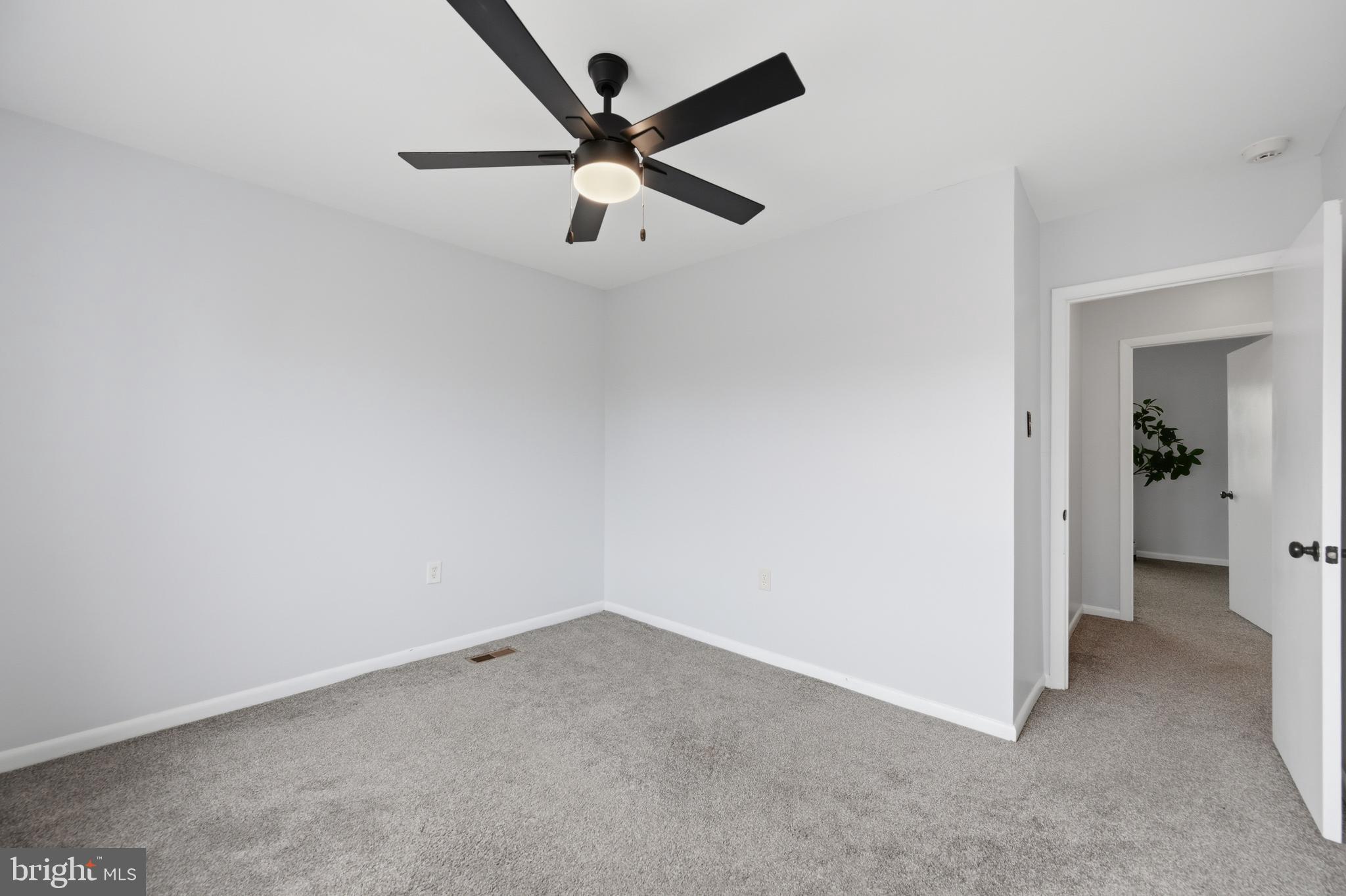 3534 6th Street Northwest Washington, DC 20010 - Photo 22 of 25 an empty room with a ceiling fan and carpet