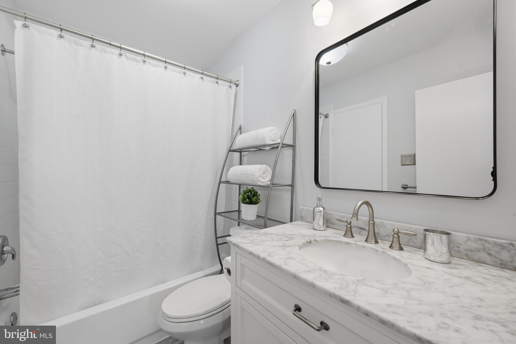 3534 6th Street Northwest Washington, DC 20010 - Photo 23 of 25 a bathroom with a granite countertop sink toilet and shower