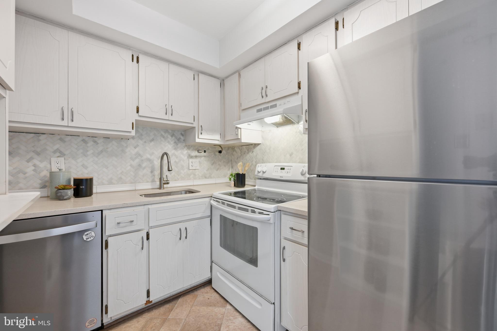 3534 6th Street Northwest Washington, DC 20010 - Photo 10 of 25 a kitchen with white cabinets and white appliances
