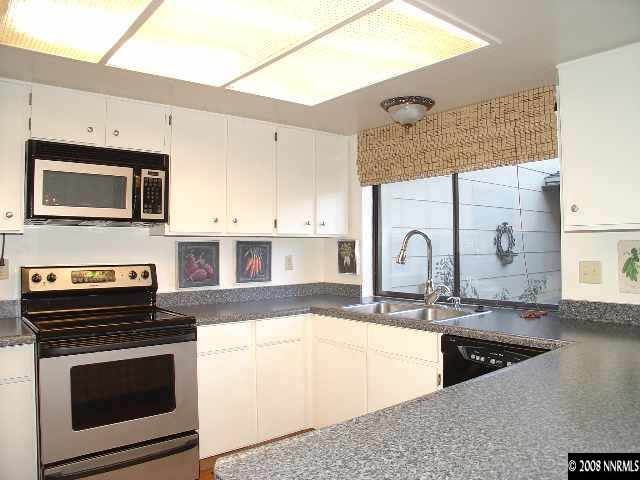 1435 Foster Drive Reno, NV 89509 - Photo 5 of 9 a kitchen with stainless steel appliances granite countertop a stove a sink and a microwave