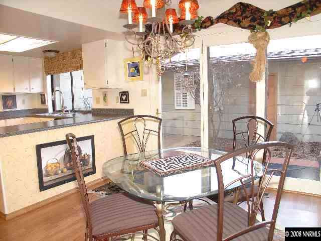 1435 Foster Drive Reno, NV 89509 - Photo 6 of 9 a view of a dining room with furniture a chandelier and wooden floor