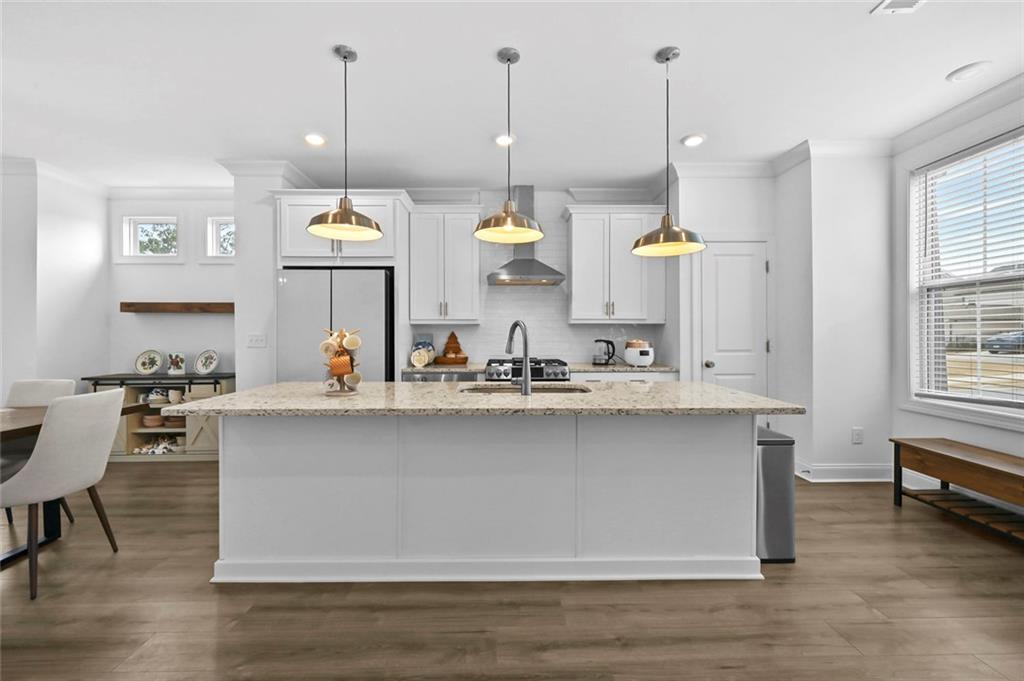 3217 Bartee Walk Suwanee, GA 30024 - Photo 11 of 36 a kitchen with a sink a counter space appliances and cabinets