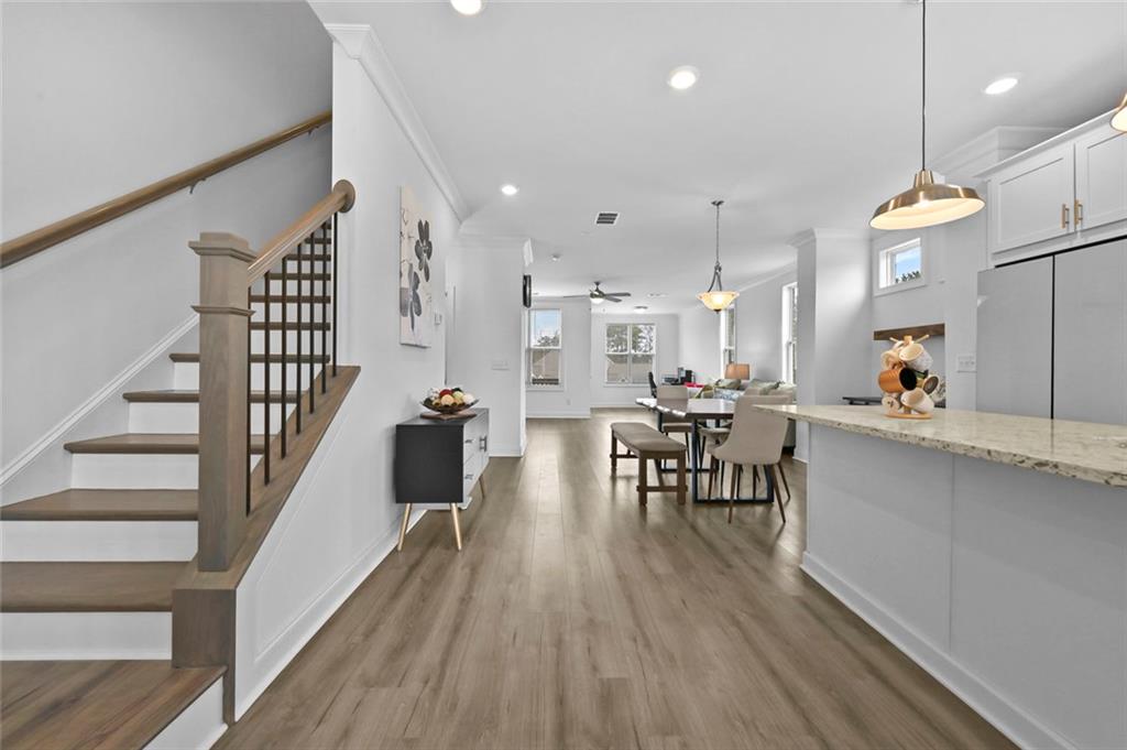 3217 Bartee Walk Suwanee, GA 30024 - Photo 13 of 36 a view of a dining room with furniture and wooden floor