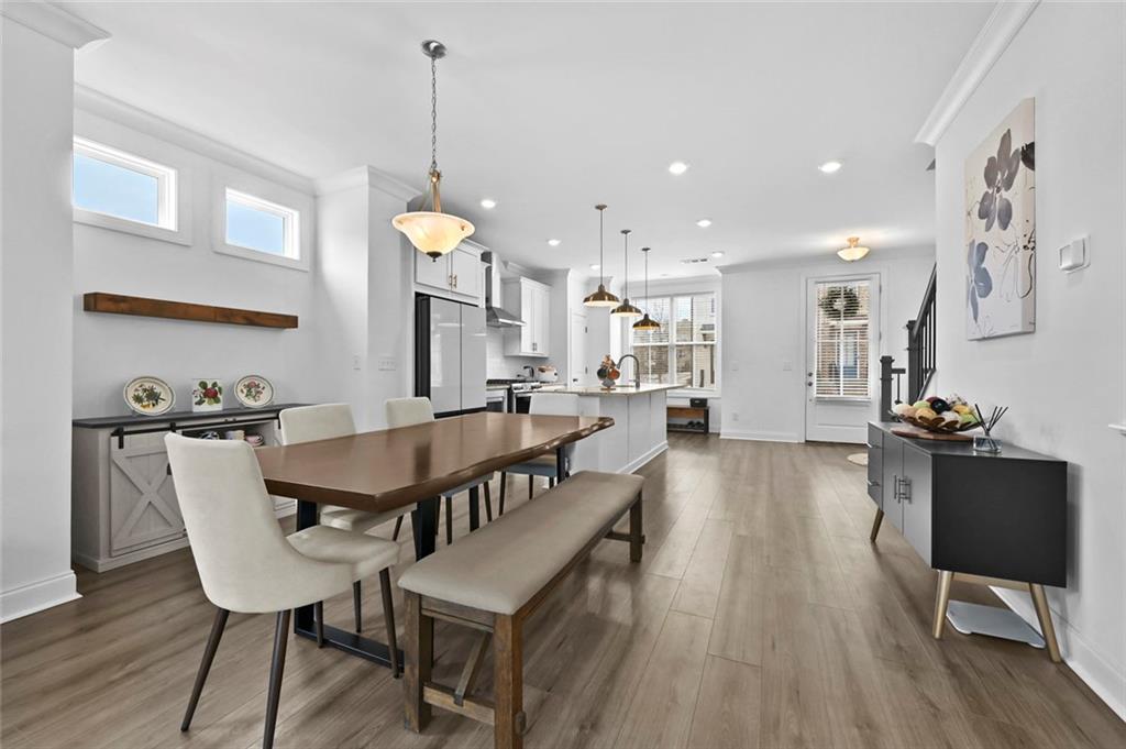 3217 Bartee Walk Suwanee, GA 30024 - Photo 16 of 36 a dining room with furniture and wooden floor