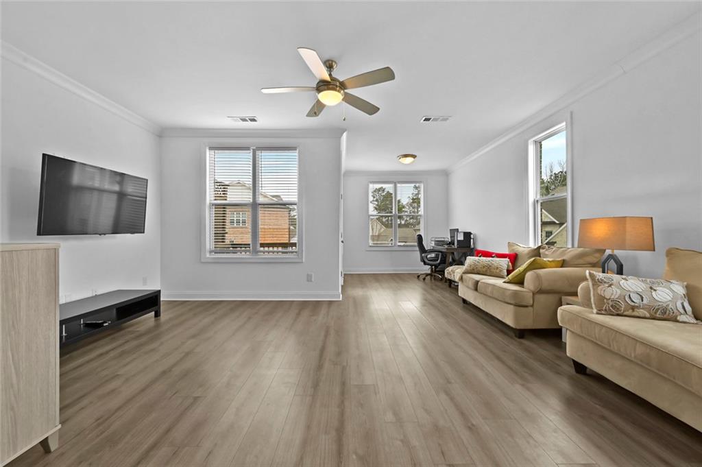 3217 Bartee Walk Suwanee, GA 30024 - Photo 17 of 36 a living room with furniture and a flat screen tv
