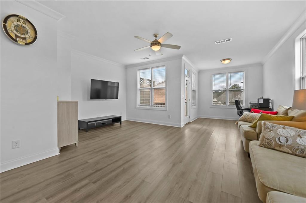 3217 Bartee Walk Suwanee, GA 30024 - Photo 18 of 36 a living room with furniture and a wooden floor