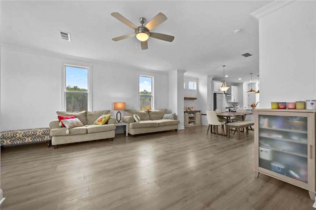 3217 Bartee Walk Suwanee, GA 30024 - Photo 21 of 36 a living room with furniture and a wooden floor