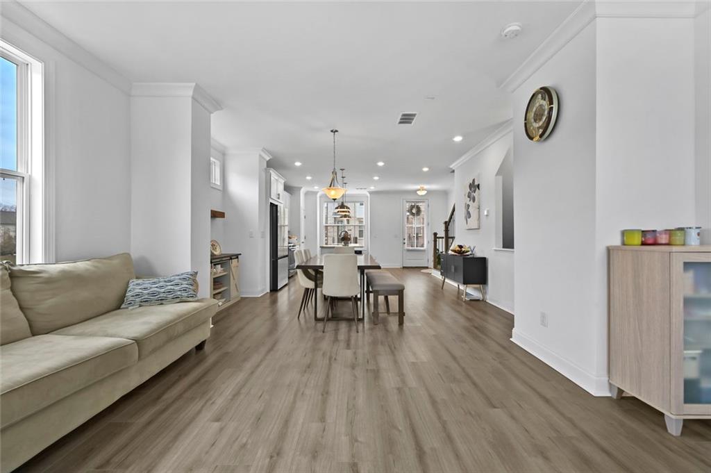 3217 Bartee Walk Suwanee, GA 30024 - Photo 22 of 36 a living room with furniture and a wooden floor