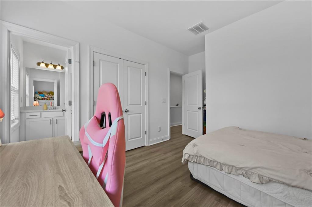 3217 Bartee Walk Suwanee, GA 30024 - Photo 30 of 36 a bedroom with a bed and a dresser