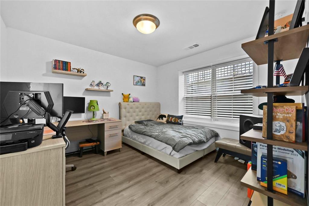 3217 Bartee Walk Suwanee, GA 30024 - Photo 33 of 36 a bedroom with a bed and a desk