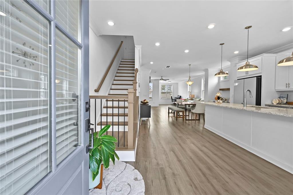 3217 Bartee Walk Suwanee, GA 30024 - Photo 9 of 36 a dining room with furniture and wooden floor