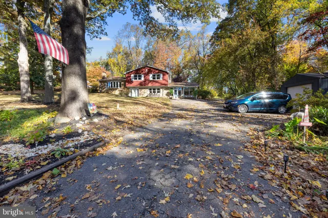a view of a street with a bench and trees