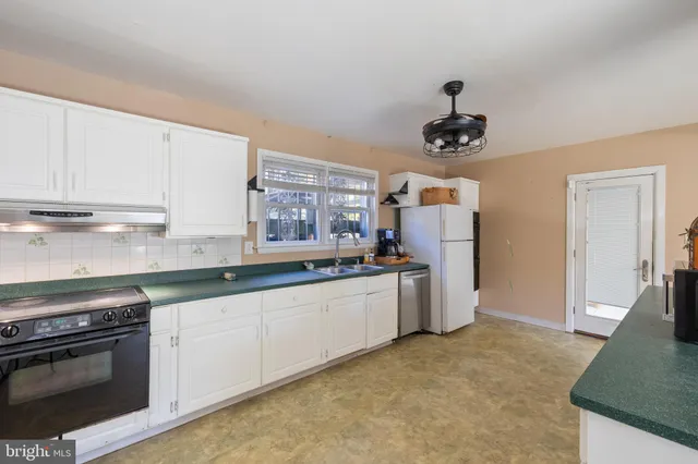 a very nice looking room with a sink a couch and chandelier