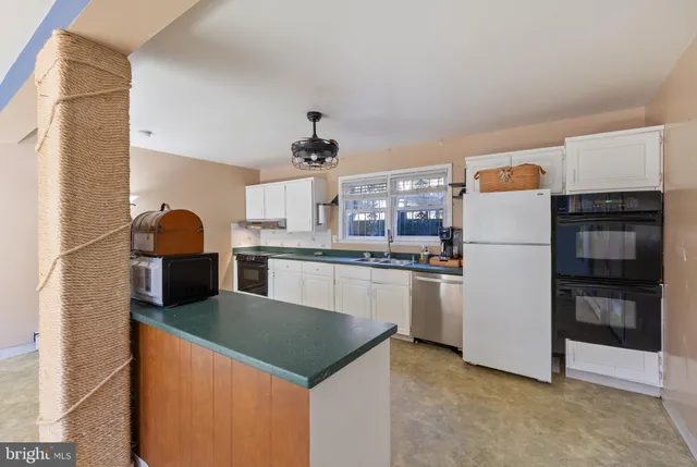 a kitchen with a counter space a sink and a window