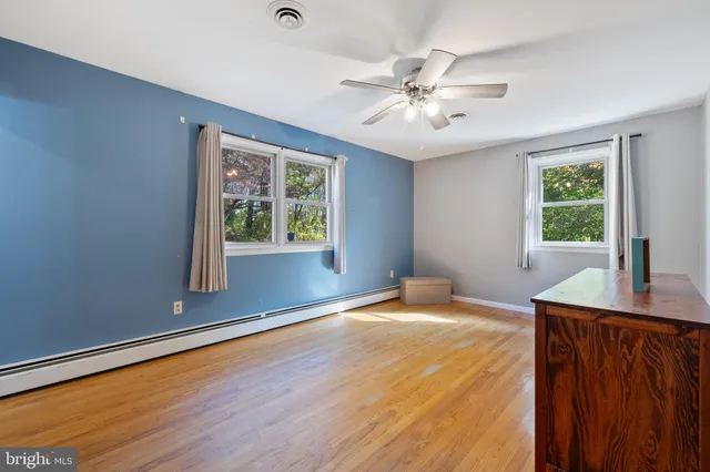 a bathroom with a granite countertop sink a toilet and a mirror