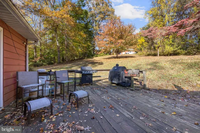 an empty room with chandelier fan and windows